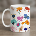 White mug with colorful floral design on a wooden surface
