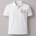 White polo shirt with 'Rise & Shine' text on a gray background