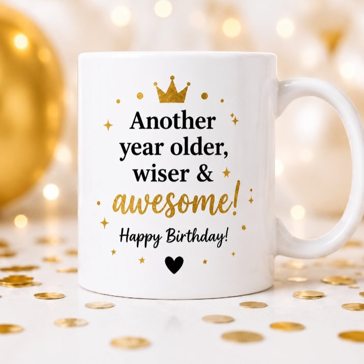 White mug with birthday message on a festive background with gold confetti and balloons.