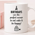 White mug with birthday-themed text and graphics on a light background
