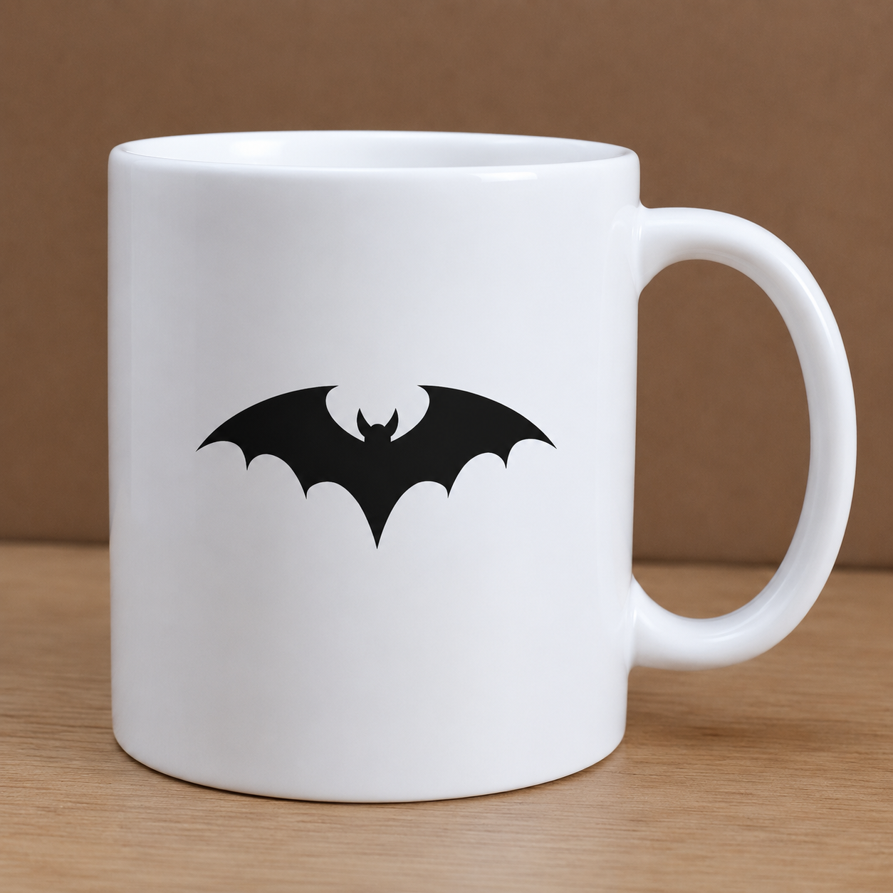 White mug with a black bat design on a wooden surface and brown background