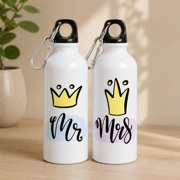 Two white water bottles with 'Mr' and 'Mrs' designs on a wooden surface.