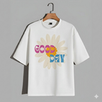 White t-shirt with a colorful 'Good Day' graphic on a hanger against a gray background