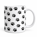 White mug with black paw print pattern on a white background