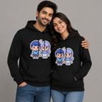 Two people wearing black hoodies with cartoon character design on a gray background