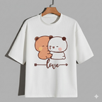 White t-shirt with cartoon bear and panda design on a hanger against a gray background