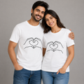 Man and woman wearing white t-shirts with heart design on a gray background
