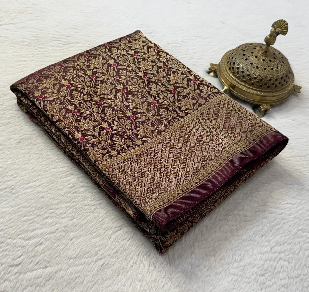Folded fabric with intricate patterns on a white surface