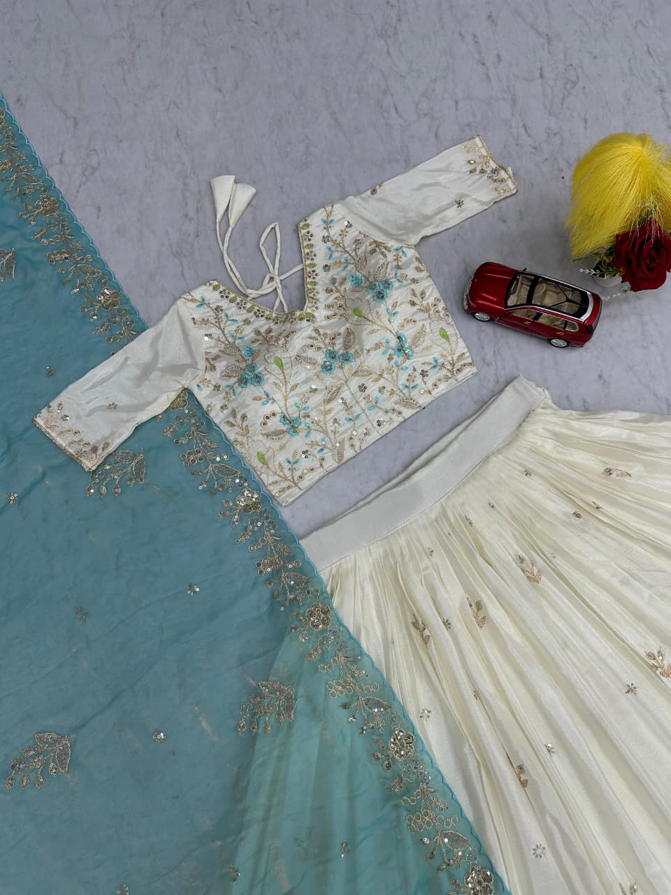 Embroidered blouse with floral patterns on a blue fabric background